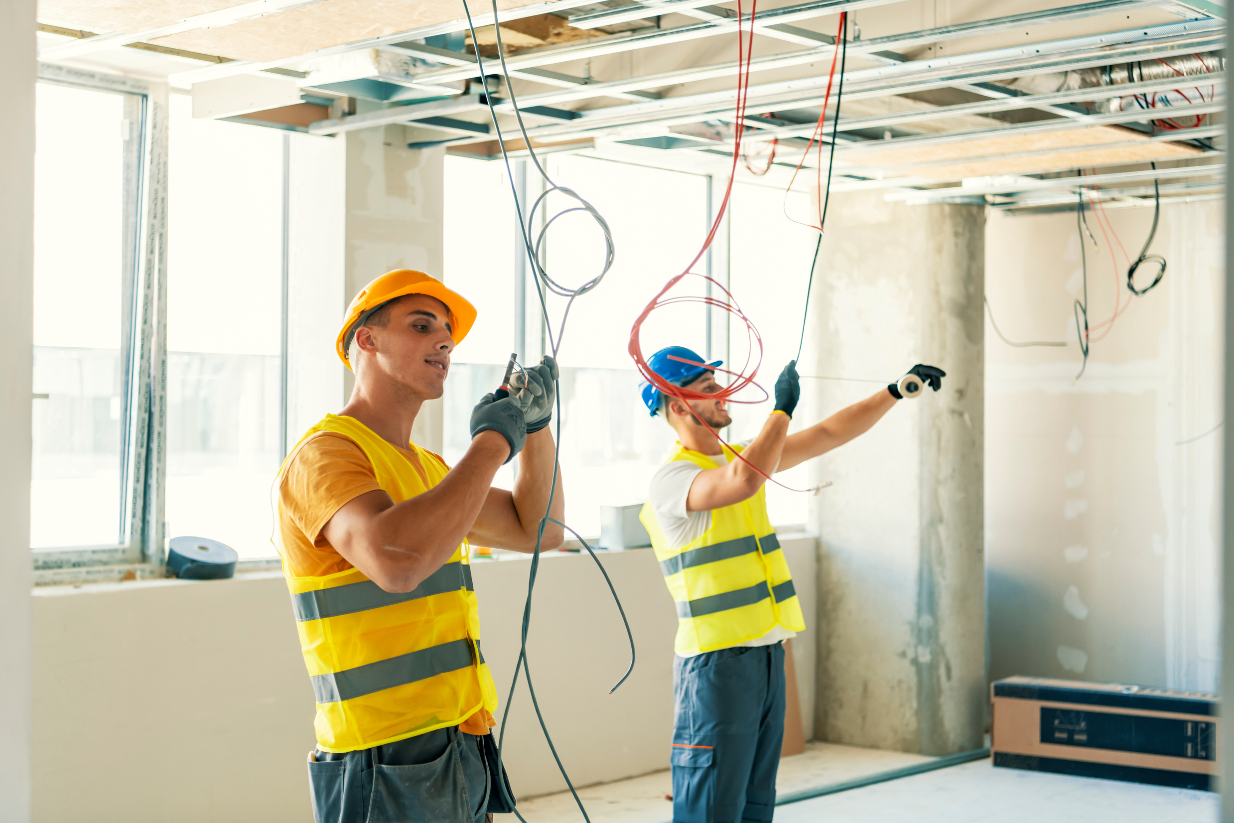 Electricians wiring a new build